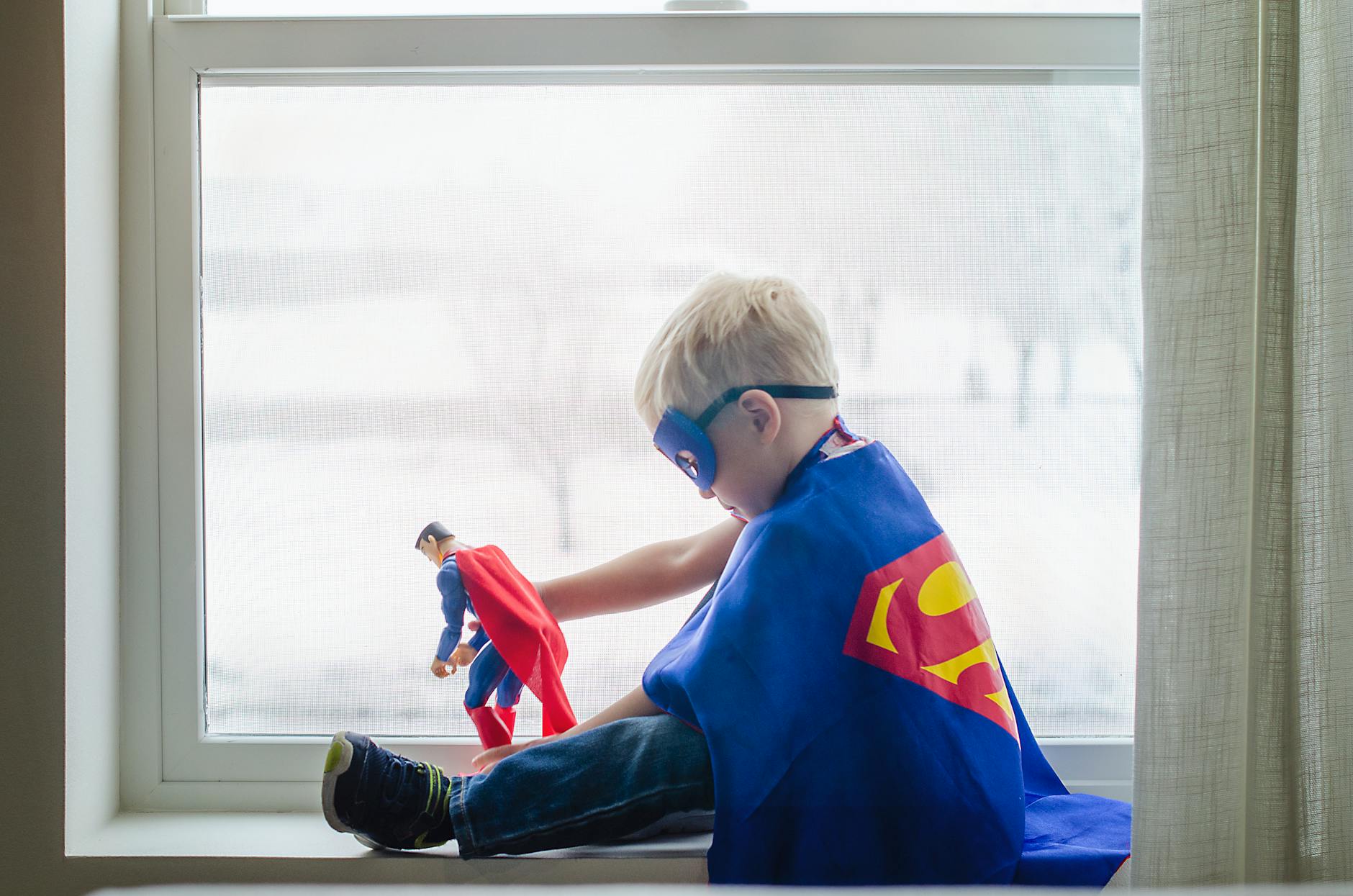 a boy wearing a superman costume