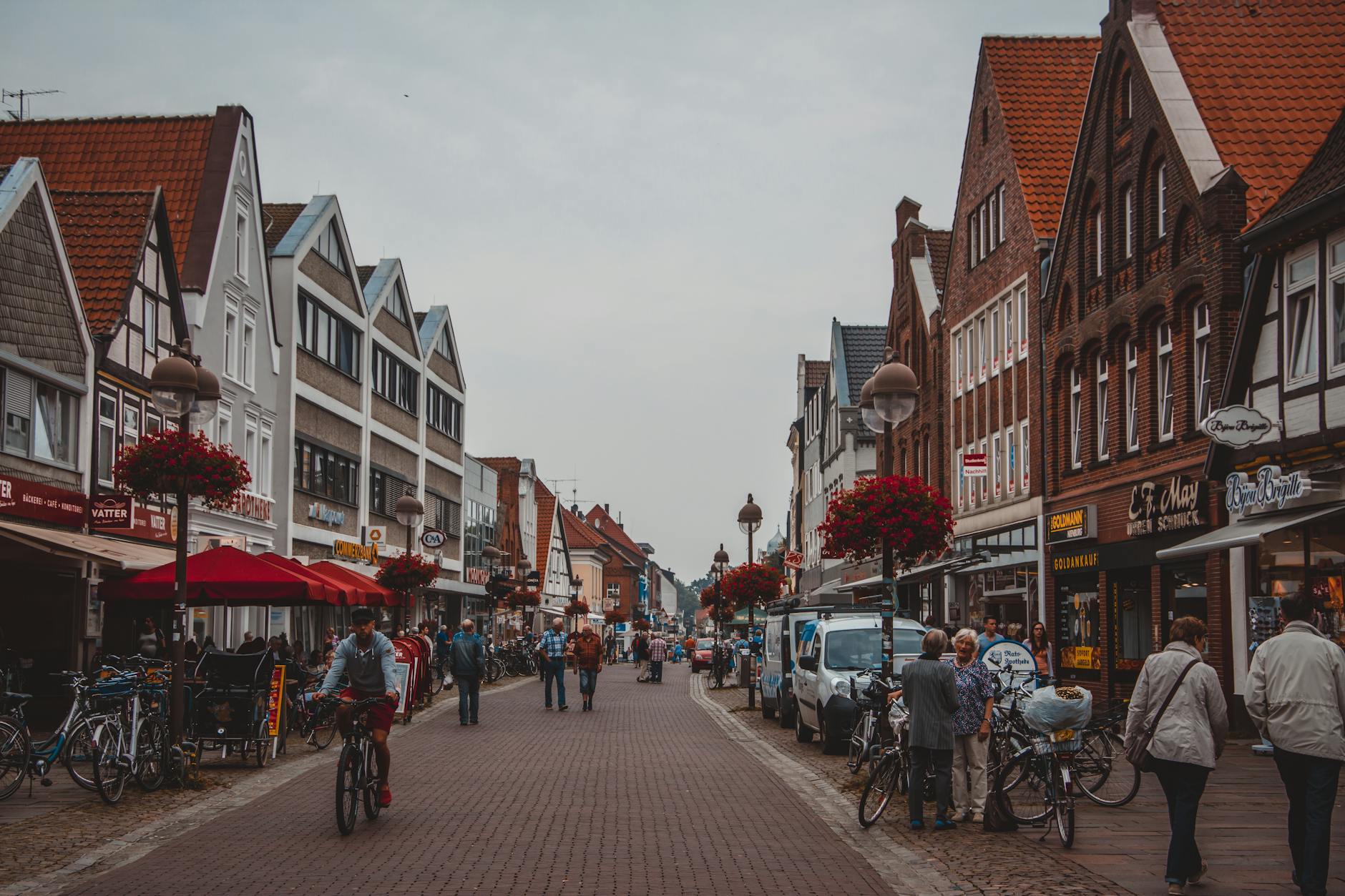 people walking on road beside buildings